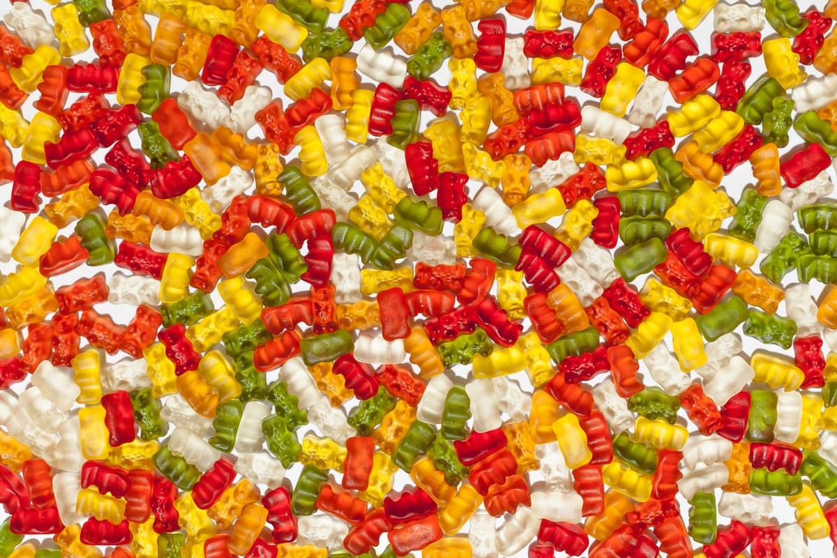 Brightly colored gummy bears in abstract arrangement, perfect for sweet lovers.